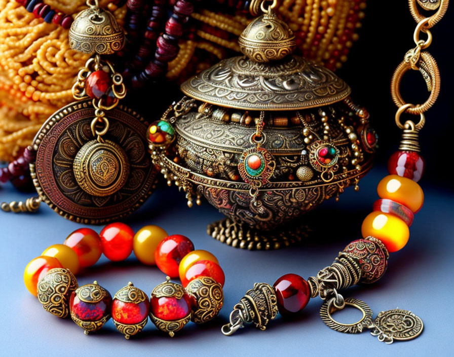 Intricate Jewelry: Beaded Necklaces, Metal Pendant, Ornate Casket on Dark Blue