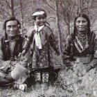 Five children in indigenous clothing with two small animals in natural setting