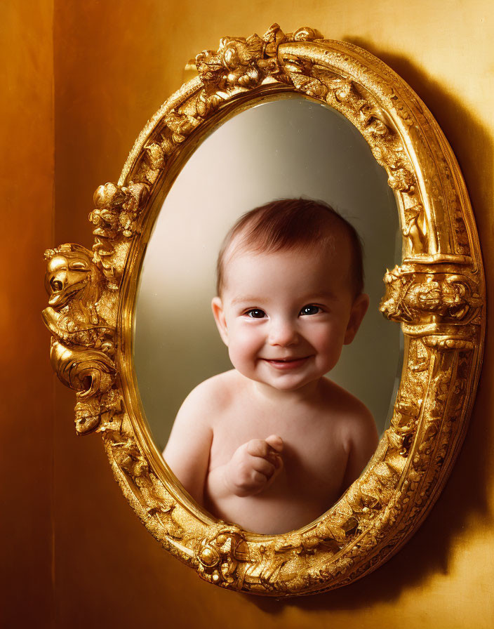 Smiling baby reflected in ornate golden mirror on yellow background