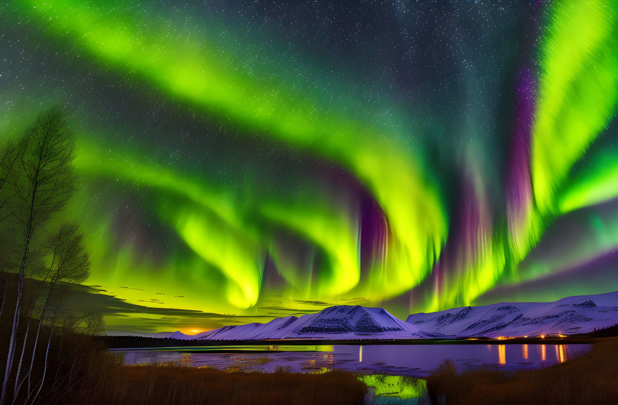 Stunning green and purple aurora borealis over snow-covered mountains