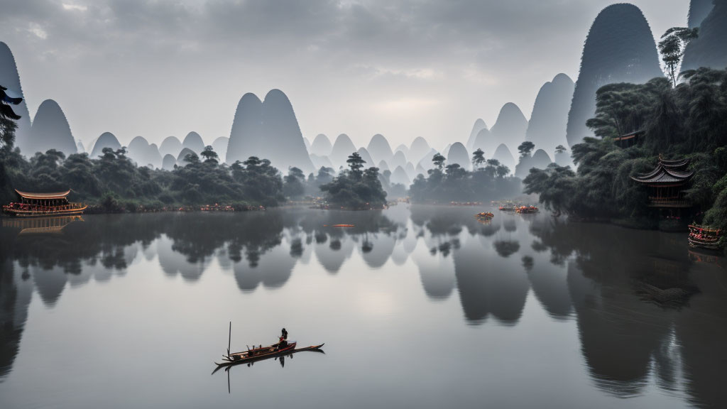 Tranquil river with boat, traditional buildings, and misty karst mountains