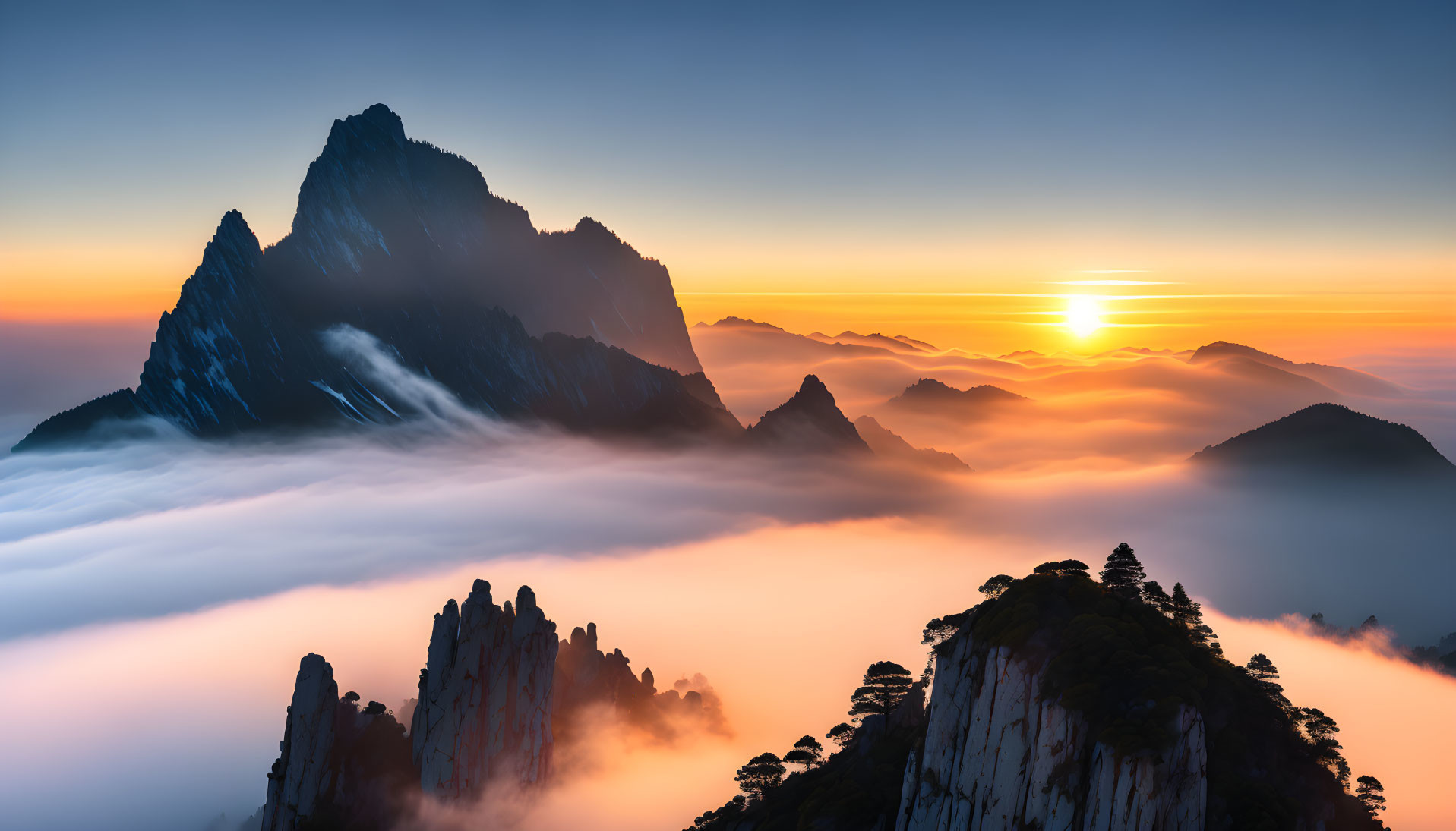 Serene mountain landscape at sunrise with misty peaks and vibrant sky