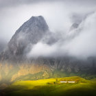 Majestic mountain landscape with mist, colorful houses, and winding path