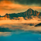 Tranquil lake with mountain range and sunset sky