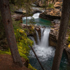 Tranquil forest waterfall with mossy rocks and vibrant foliage