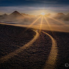 Scenic sunrise over rolling hills with mountain range and path