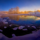 Snowy River Landscape with Orange Sky at Sunset or Sunrise