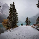 Person admiring misty turquoise lake in winter scene