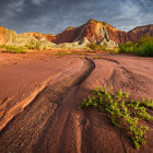 Winding River in Desert Landscape with Dramatic Sky