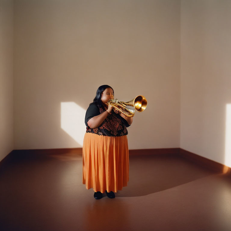 Musician playing trombone in dim room with shadows wearing black top and orange skirt