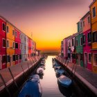 Futuristic domed structures by reflective water at sunset