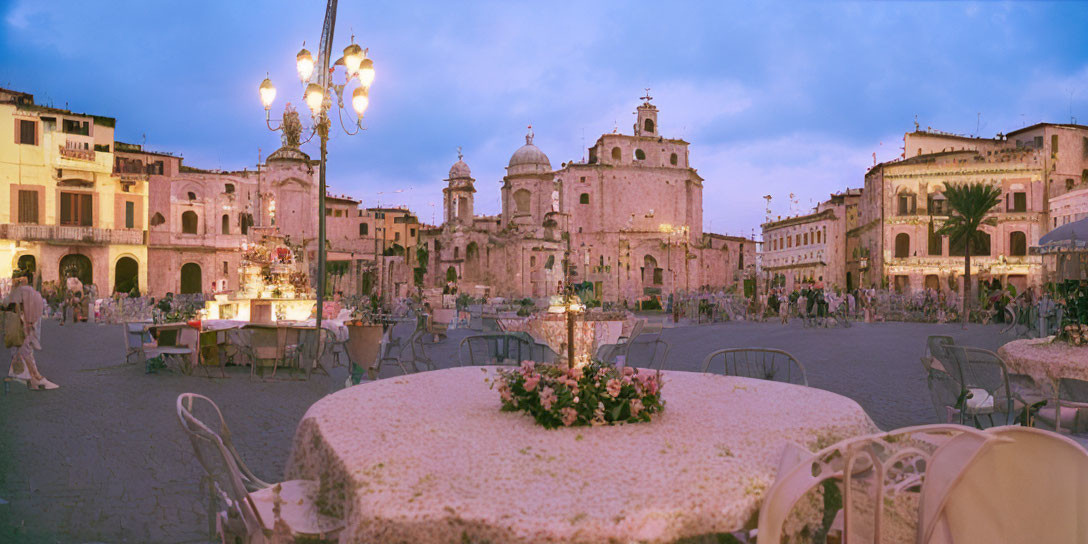 Bustling European Square at Dusk with Cafe Tables