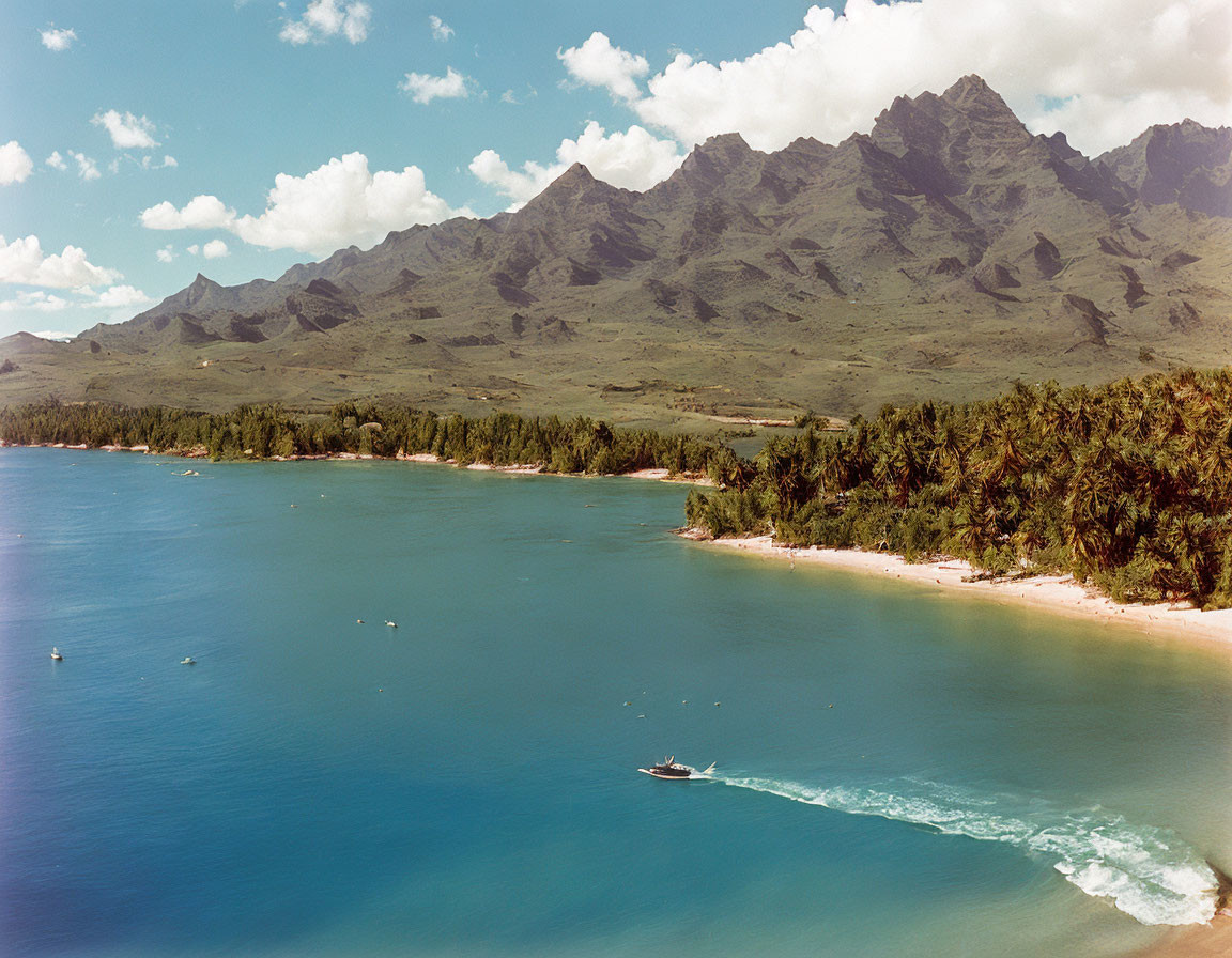 Tranquil Coastal Landscape with Beach, Boat, and Mountains