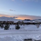 Snow-covered houses at dawn in tranquil winter panorama