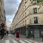 Rainy Paris Street Scene with Eiffel Tower and Umbrellas