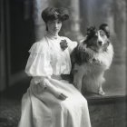 Vintage-dressed woman with two dogs in elegant setting