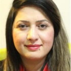 Portrait of woman with long brown hair and red blouse smiling