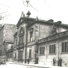 Faded vintage street scene with classic architecture and people milling about