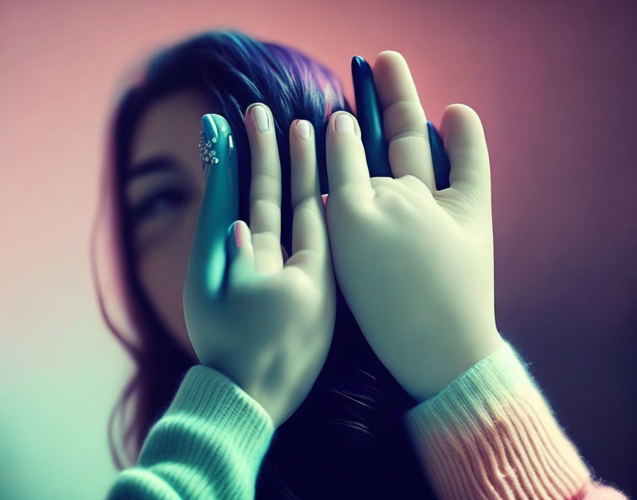 Brightly Colored Nails Person Covering Face Soft Focus Cool-Toned Backdrop