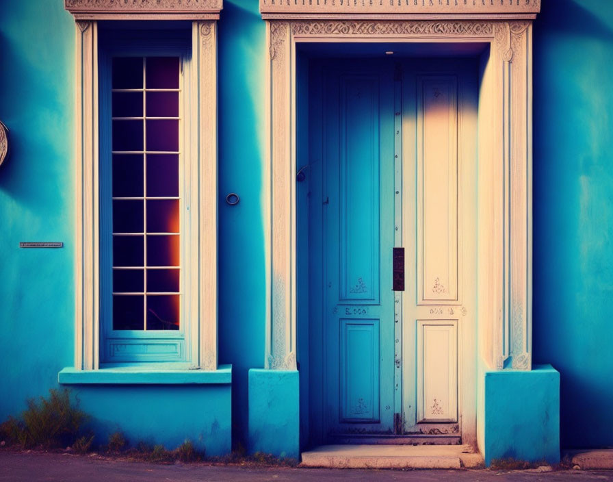 Classic Blue-Painted Building with Vintage Doorway and Window