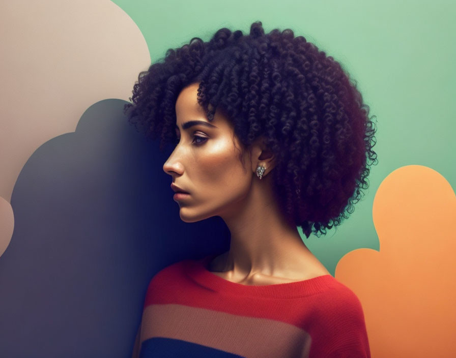 Portrait of woman with curly hair in striped top on pastel cloud backdrop