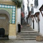 Traditional architectural design featuring elegant archways, ornate doors, and decorative exterior under clear skies