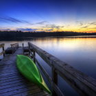 Surreal landscape with ornate gondolas on calm lake at sunset