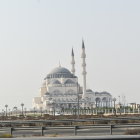 Grand Mosque with Golden Domes and Minarets Reflecting in Water