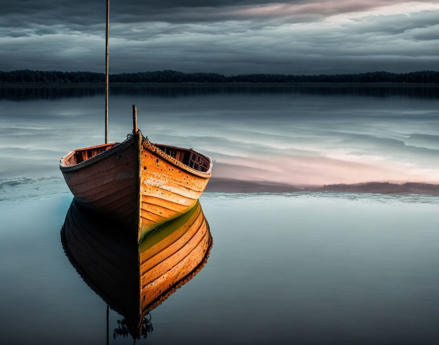 Tranquil image of orange and green boat on calm water with cloudy sky