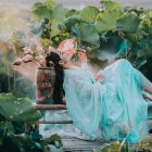 Two young girls in floral crowns among vibrant flowers on stone bench