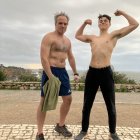 Muscular men in surreal landscape with cactus-like plants