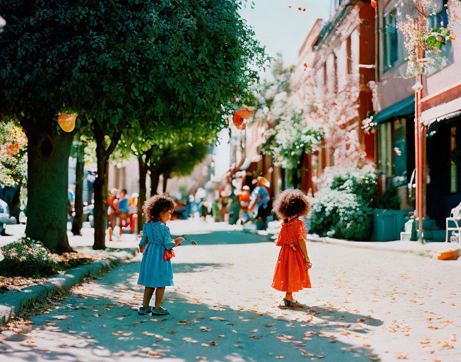 Two curly-haired children on tree-lined street in blue and orange.