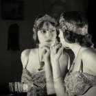 Elegantly Dressed Women with Floral Crowns and Candle