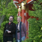 Traditional Japanese Kimonos Amidst Lush Greenery and Ornate Building