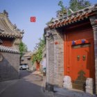 Vintage Attire and Traditional Chinese Architecture in Vibrant Street Scene