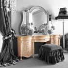 Monochrome room with classic vanity table, ornate mirror, tree sculpture, decorative birds, modern art