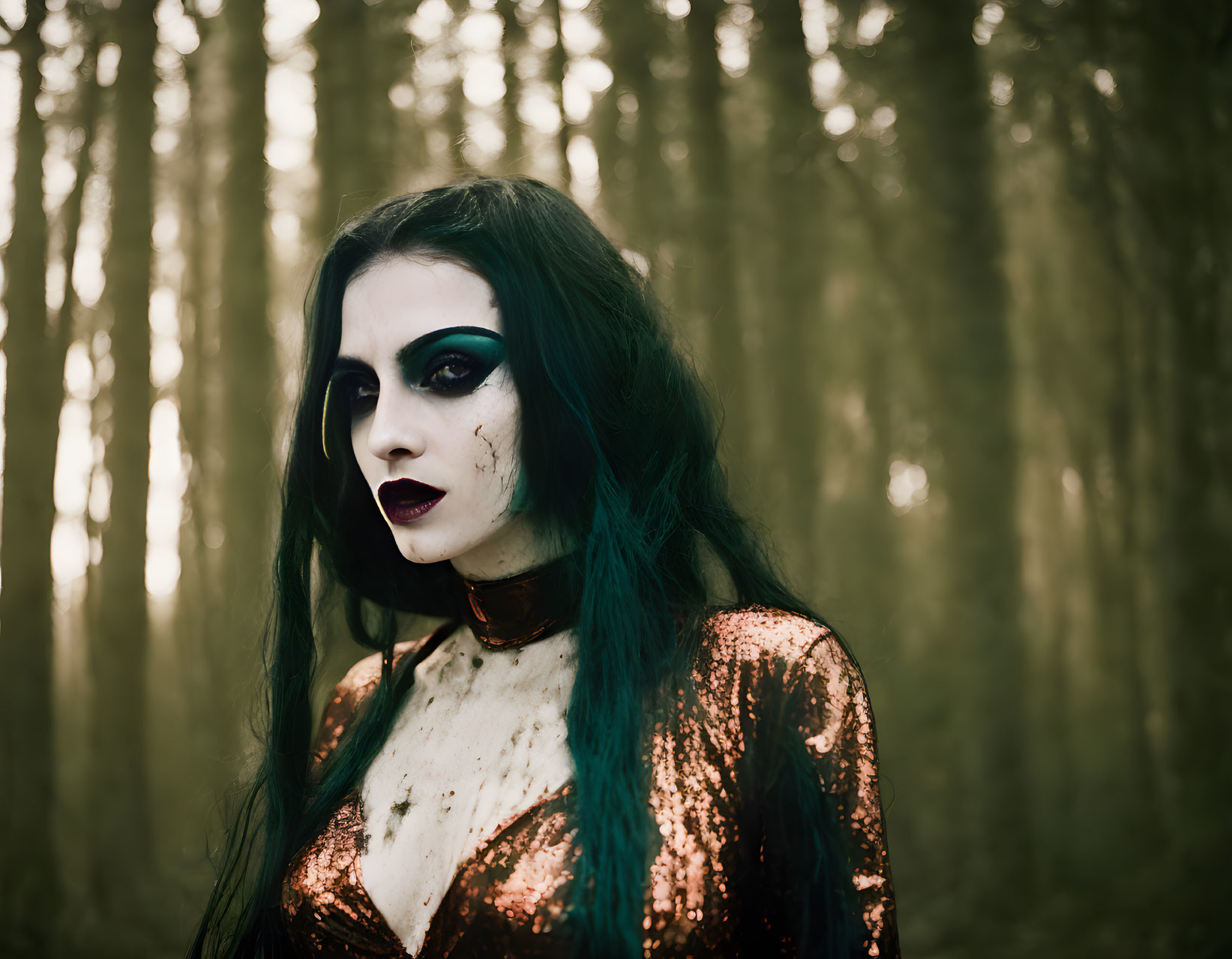 Woman in dramatic makeup and sequined outfit in misty forest