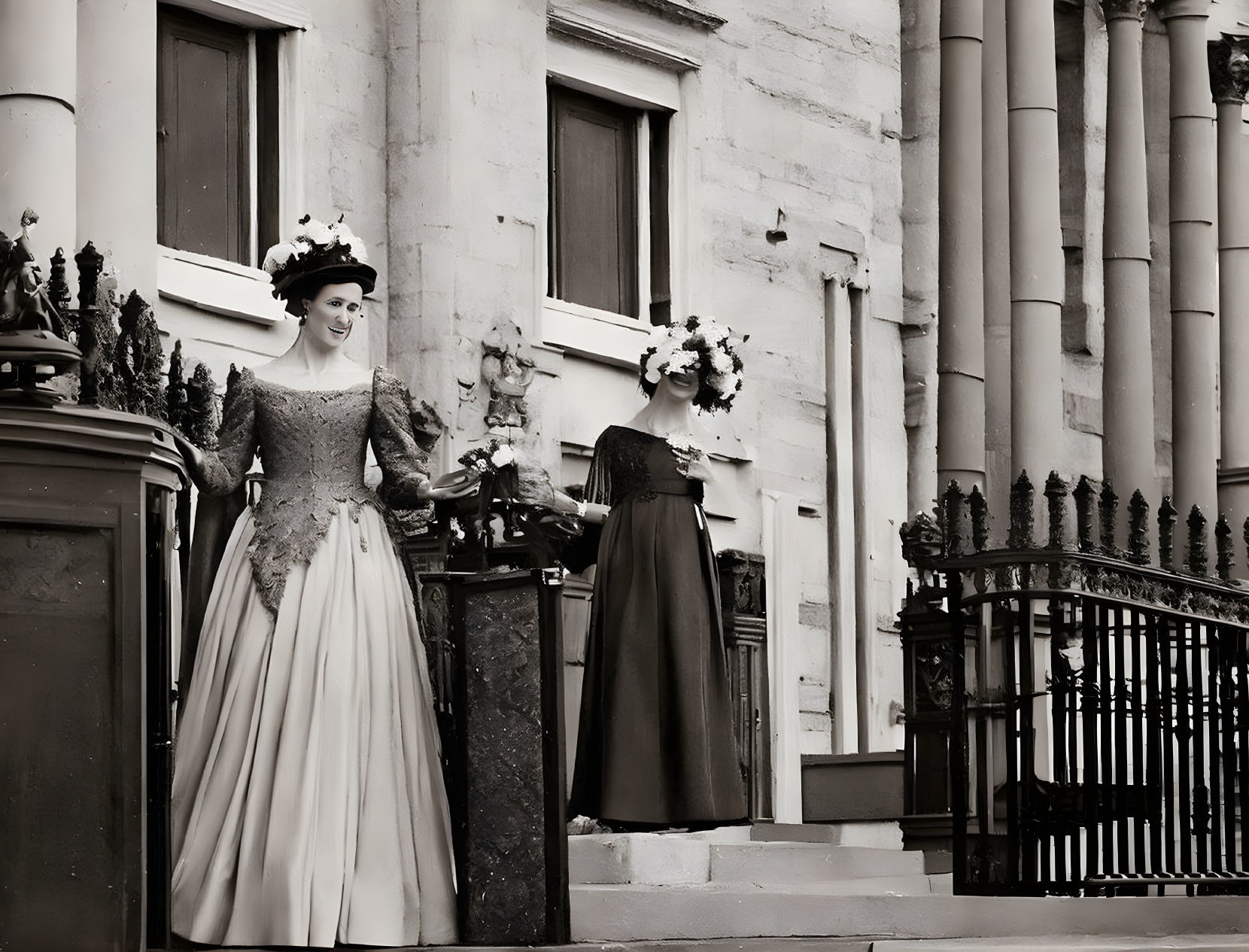 Vintage-dressed women posing by classical building with columns