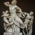 Marble sculpture of seated man with two children on dark background