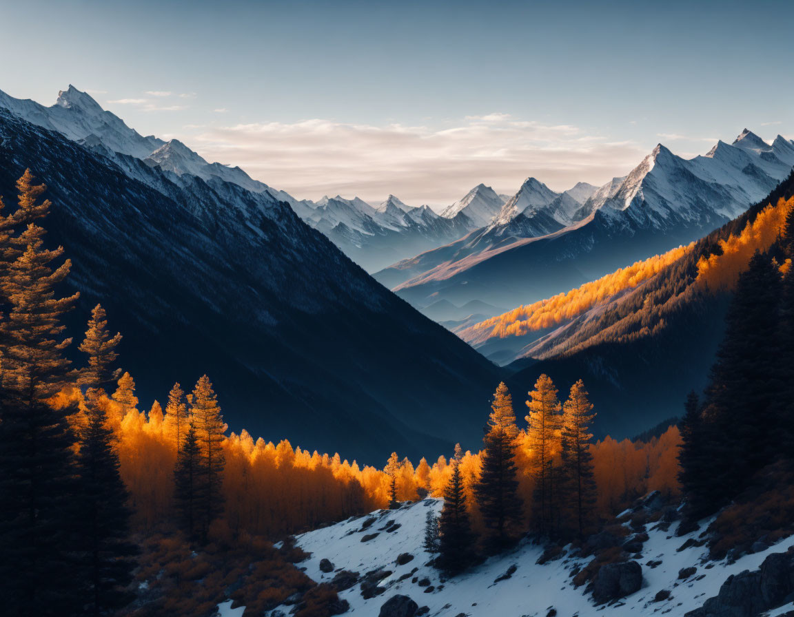 Scenic snow-covered mountains and golden-hued valley in sunlight