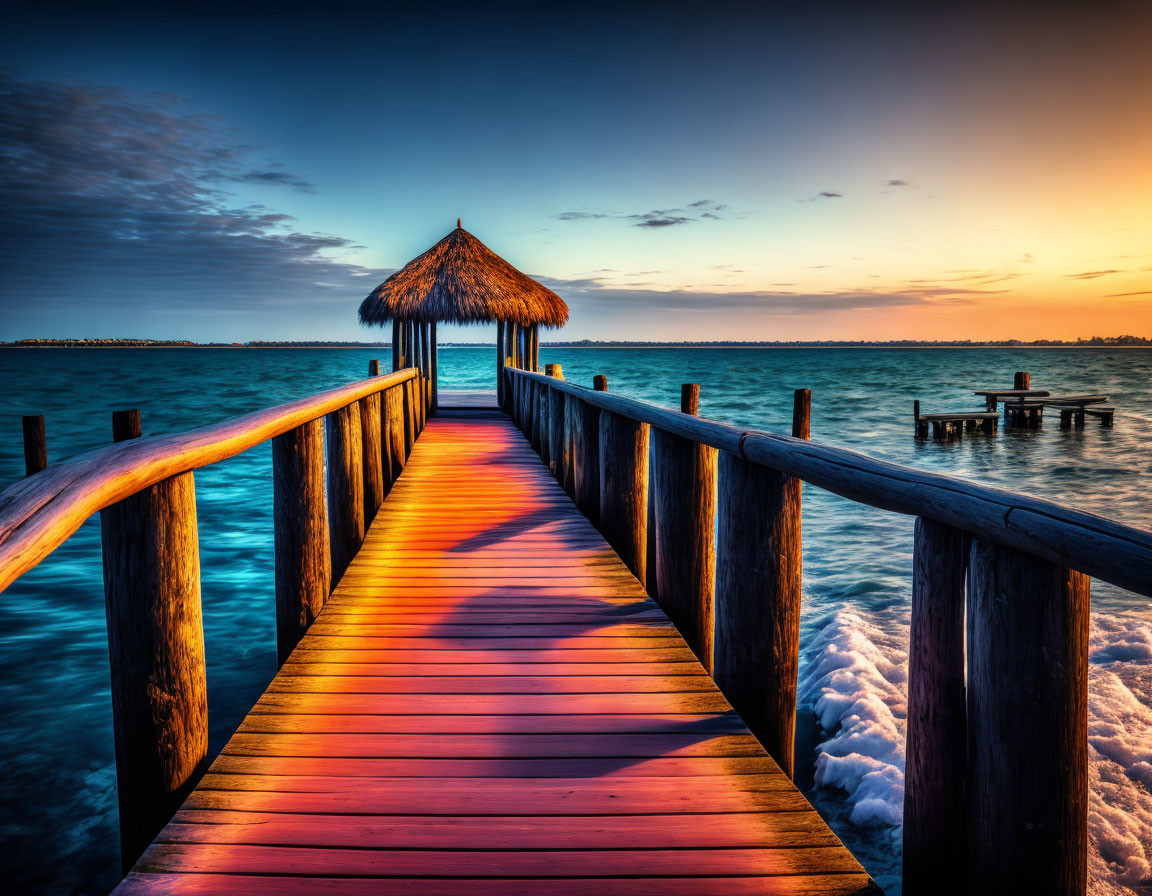 Thatched hut on wooden pier at sunset with vibrant colors