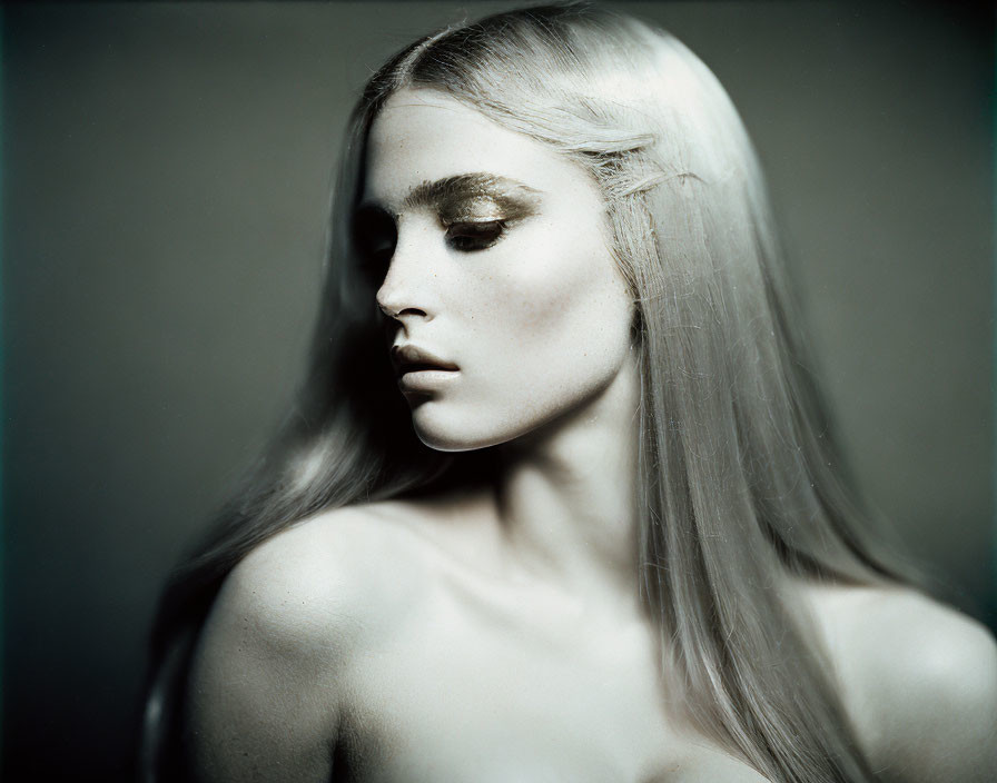 Monochrome portrait of woman with long blonde hair and dramatic eyebrows