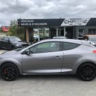 Silver Sports Coupe with Black Accents Parked Near Building and Another Car