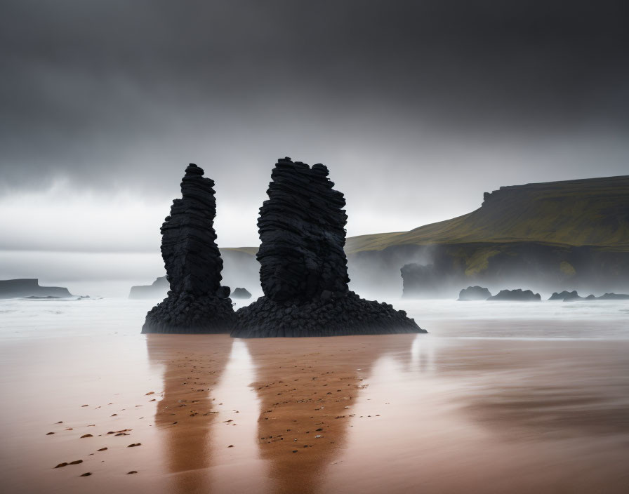 Majestic rock formations on wet beach under cloudy sky