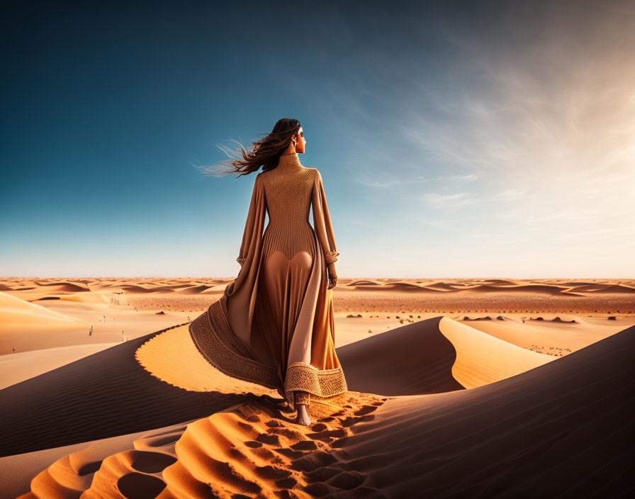 Woman in flowing dress on sand dune gazes at desert landscape