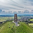 Historic tower in scenic countryside landscape with grazing sheep