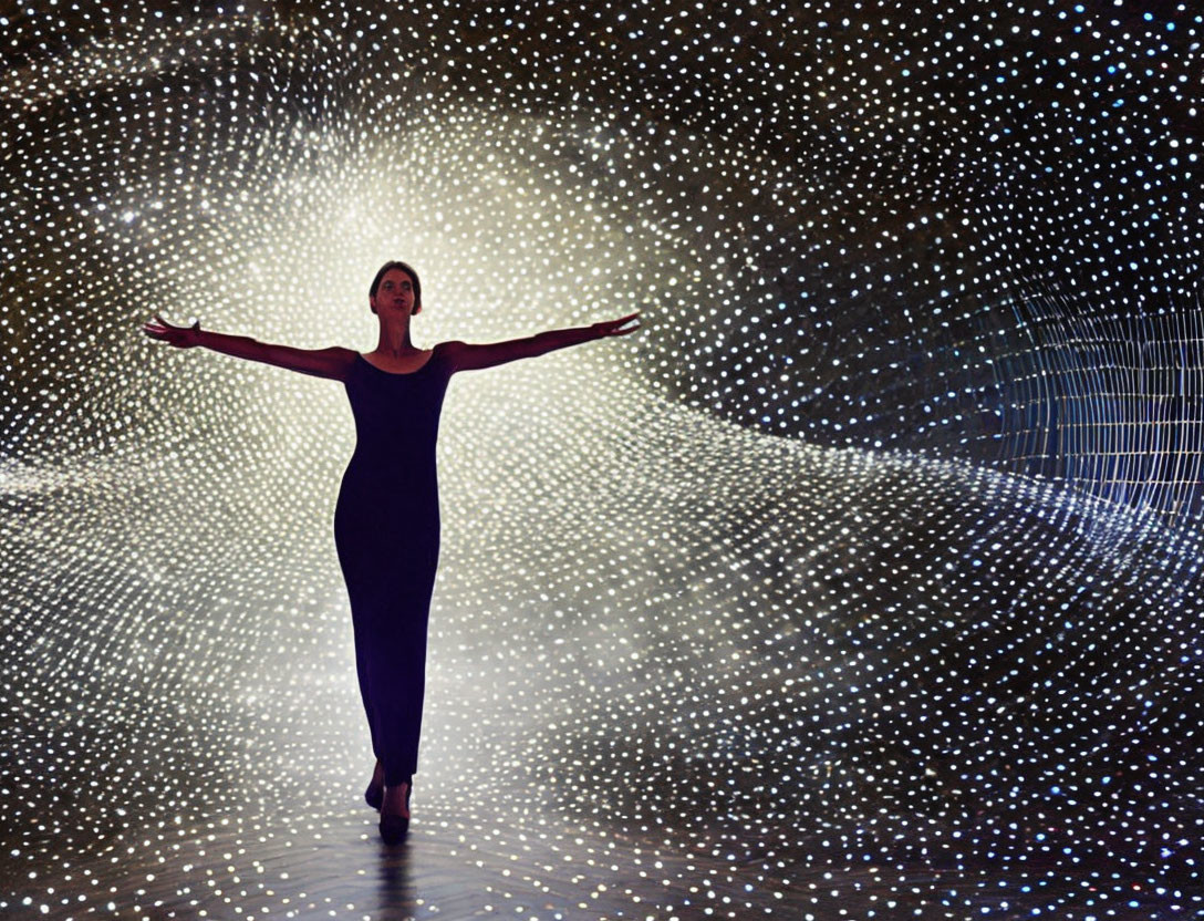 Woman walking in illuminated tunnel with twinkling lights