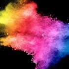 Colorful ink splashes merge in mid-air on black background - dynamic abstract display