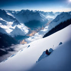 Snow-covered mountain landscape with illuminated river and blue-tinted peaks