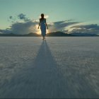 Silhouette of Person Standing on Flat Surface at Dusk